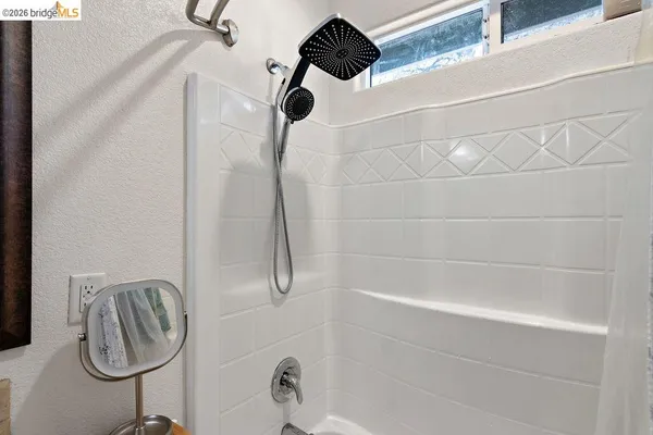 a bathroom with a granite countertop sink a toilet and a mirror