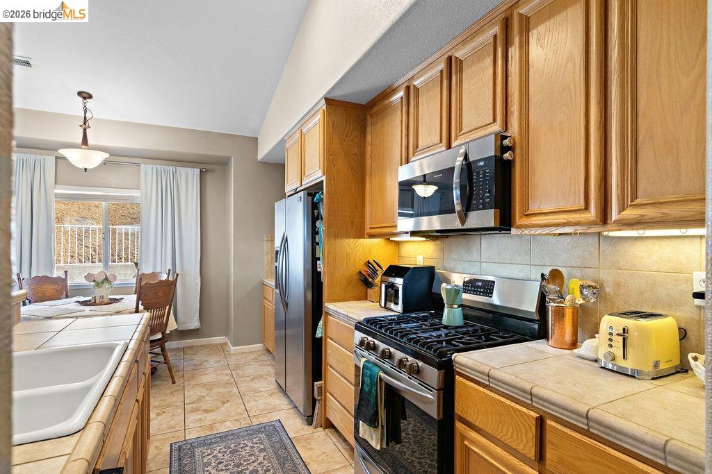 4955 Little John Road Copperopolis, CA 95228 - Photo 24 of 60 a kitchen with stainless steel appliances granite countertop a stove a sink and a microwave