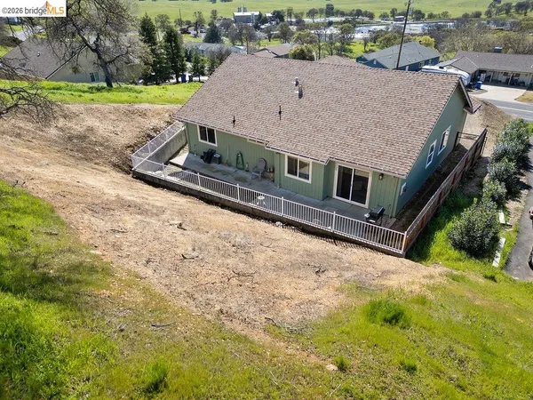 an aerial view of a residential houses with outdoor space