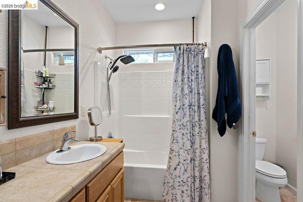 4955 Little John Road Copperopolis, CA 95228 - Photo 40 of 60 a bathroom with a granite countertop sink toilet and shower