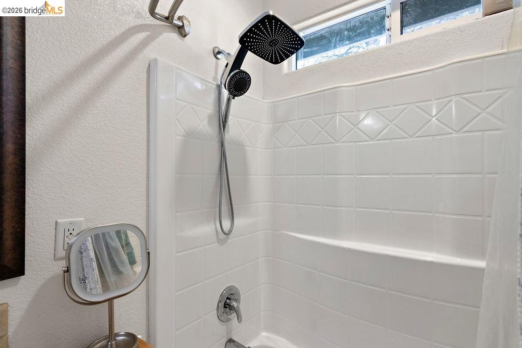4955 Little John Road Copperopolis, CA 95228 - Photo 42 of 60 Full bathroom featuring a textured wall and shower / tub combo with curtain