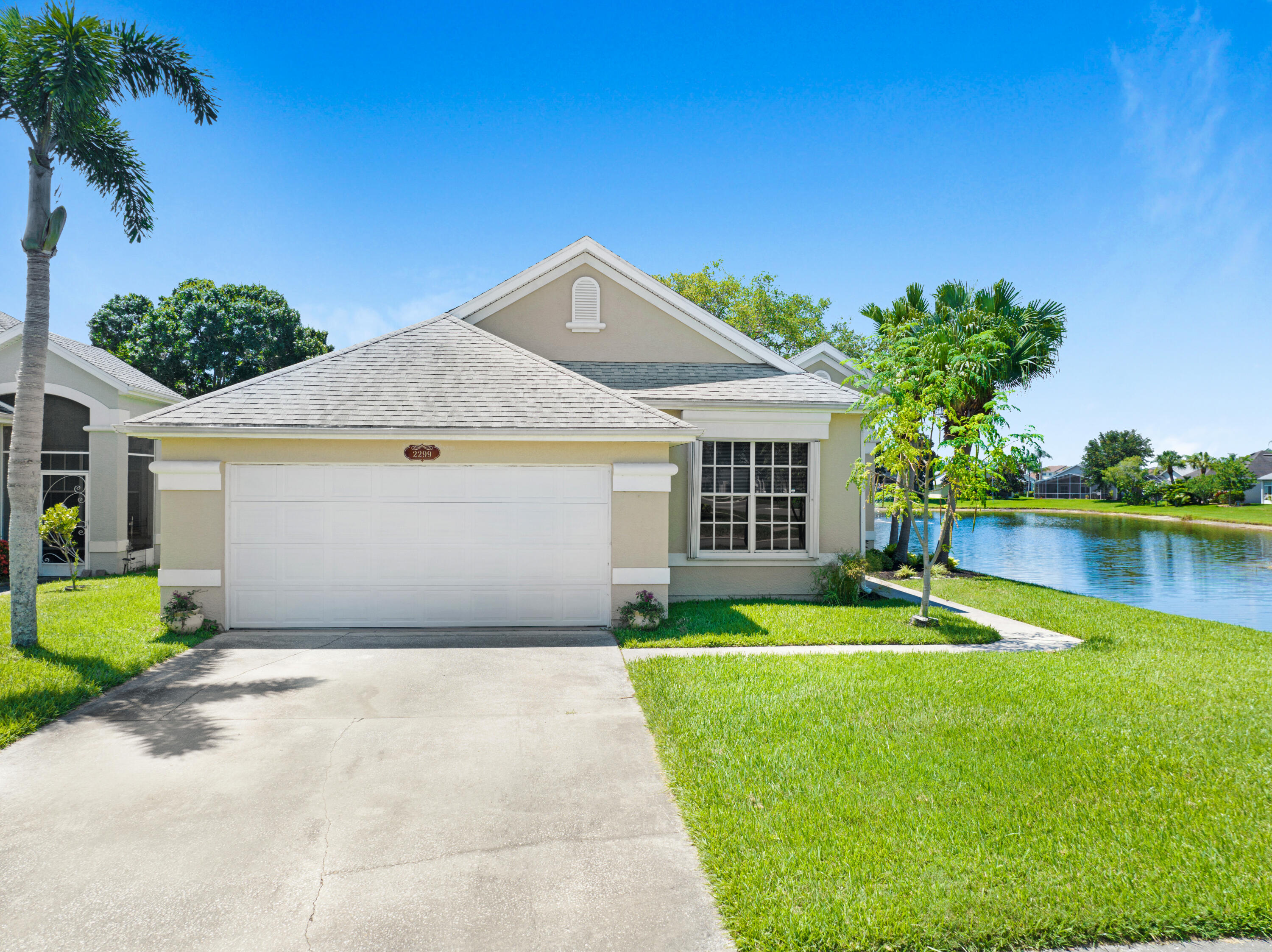 2299 Addington Circle Rockledge, FL 32955 - Photo 1 of 61 a front view of a house with a yard and garage