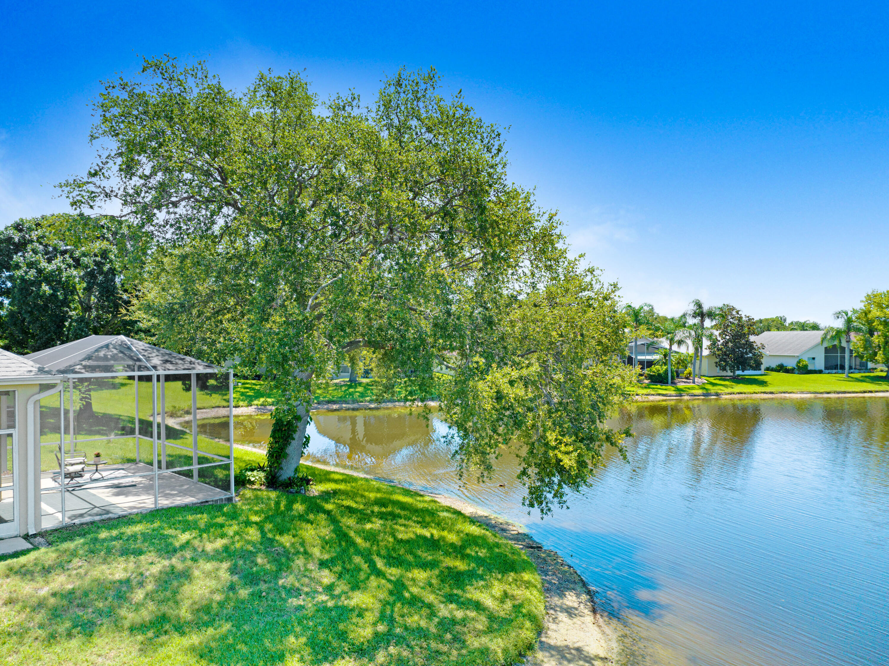 2299 Addington Circle Rockledge, FL 32955 - Photo 2 of 61 a view of a lake with houses in the back