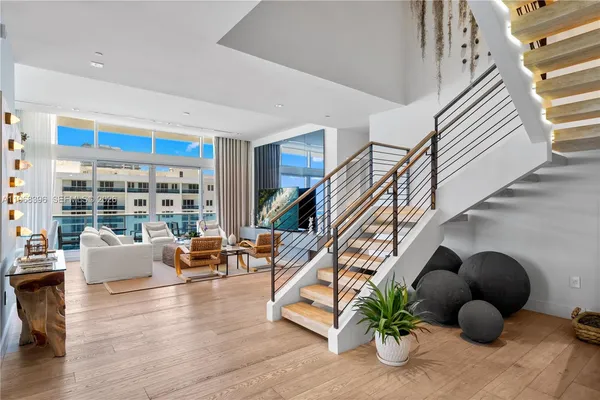 a view of a balcony with floor to ceiling windows and stairs