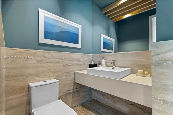 a view of a hallway with workspace and a bathroom