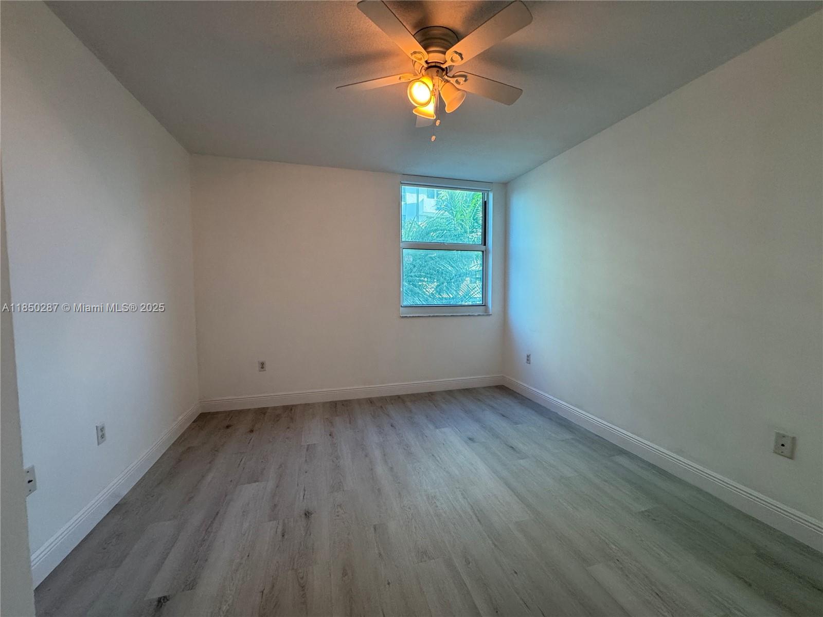 9201 Collins Avenue, Unit 323 Surfside, FL 33154 - Photo 15 of 46 an empty room with a window and a fan