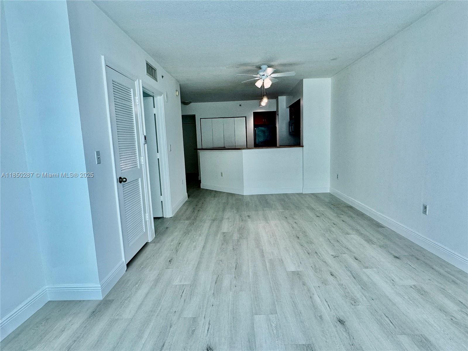 9201 Collins Avenue, Unit 323 Surfside, FL 33154 - Photo 16 of 46 a view of a room with wooden floor