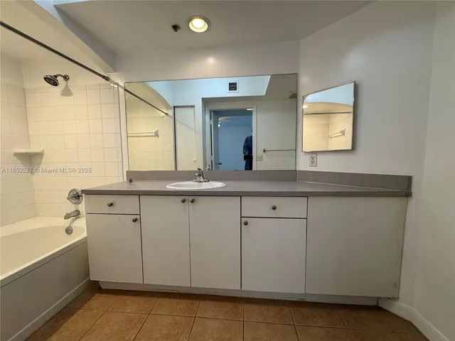 a bathroom with a tub and a shower