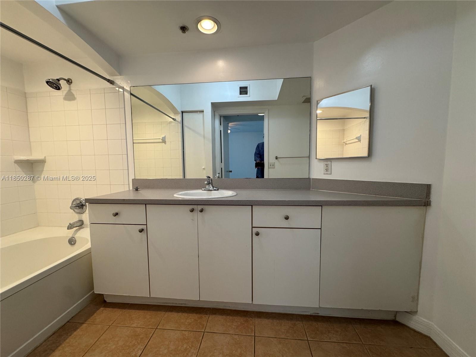 9201 Collins Avenue, Unit 323 Surfside, FL 33154 - Photo 19 of 46 a bathroom with a sink and a mirror