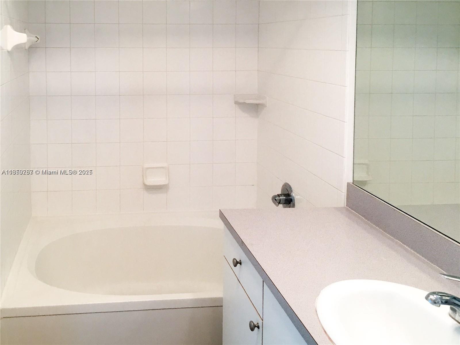 9201 Collins Avenue, Unit 323 Surfside, FL 33154 - Photo 20 of 46 a bathroom with a tub and a shower