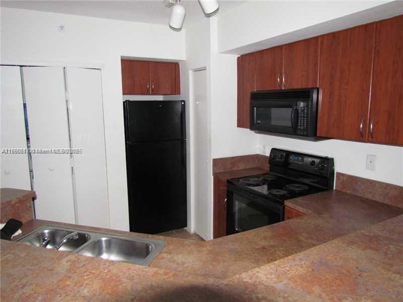 9201 Collins Avenue, Unit 323 Surfside, FL 33154 - Photo 24 of 46 a kitchen with a refrigerator stove and microwave