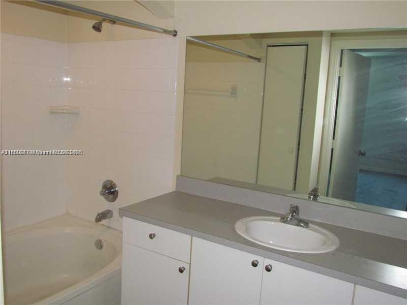 9201 Collins Avenue, Unit 323 Surfside, FL 33154 - Photo 25 of 46 a bathroom with a sink a toilet and shower