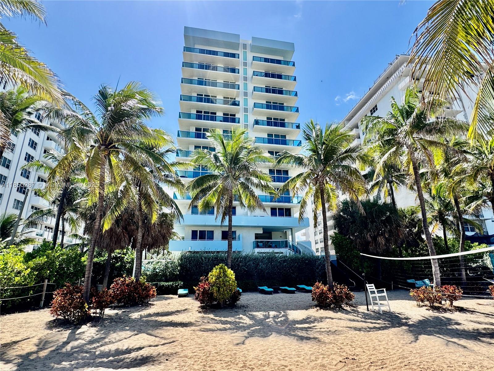 9201 Collins Avenue, Unit 323 Surfside, FL 33154 - Photo 3 of 46 a front view of a building with palm trees