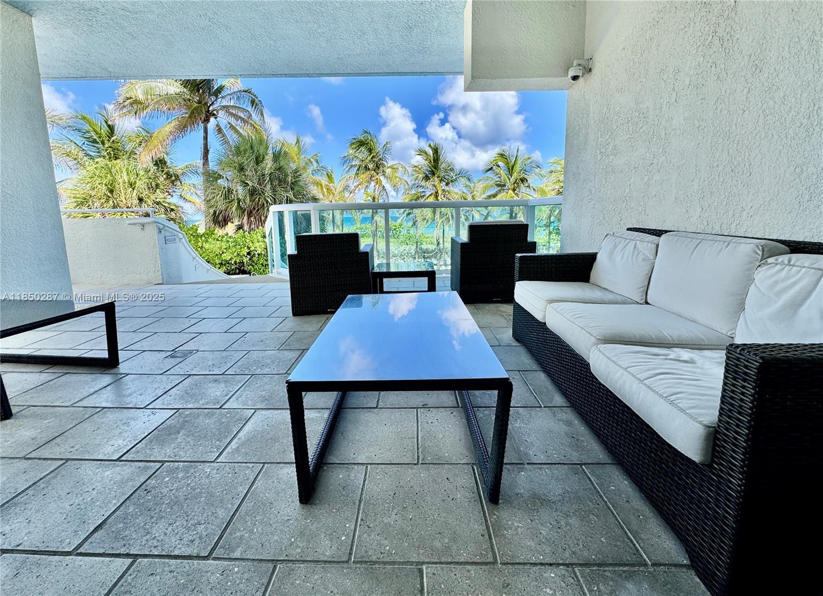 9201 Collins Avenue, Unit 323 Surfside, FL 33154 - Photo 33 of 46 a living room with furniture and a potted plant