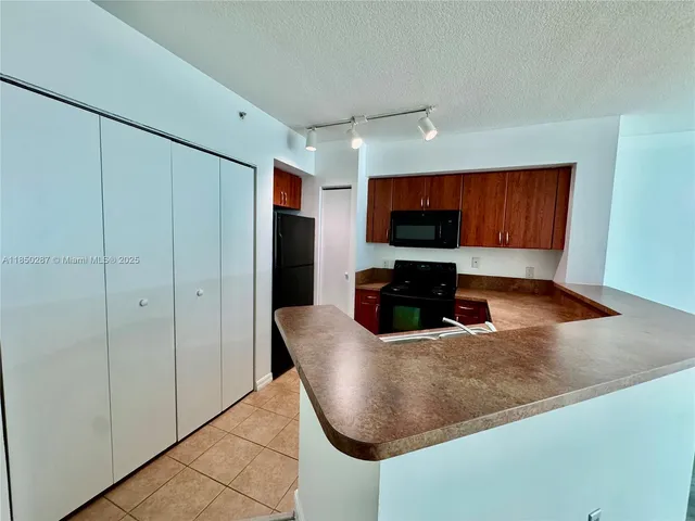 a kitchen with a sink stove and microwave
