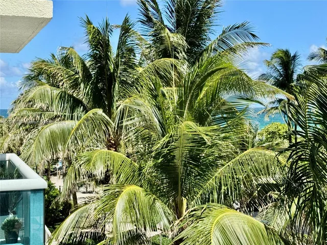 a bathroom with a granite countertop sink a mirror and a bathtub