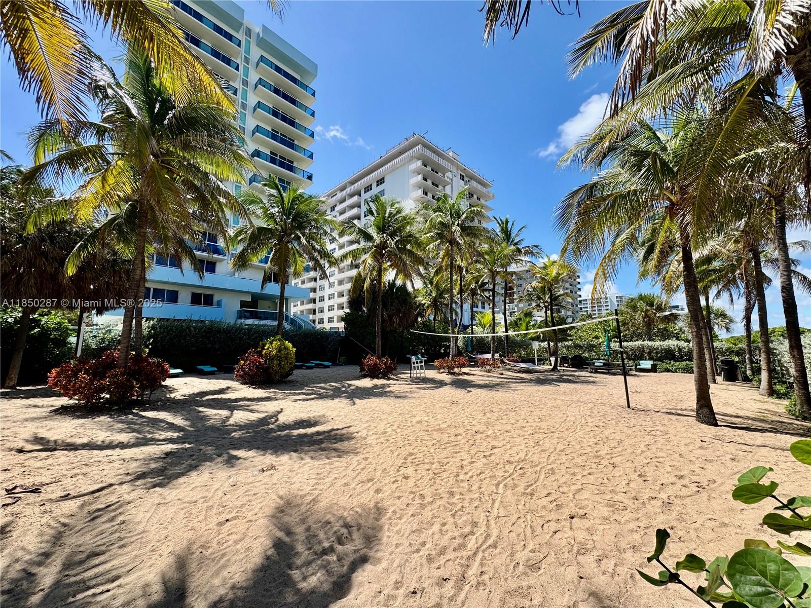 9201 Collins Avenue, Unit 323 Surfside, FL 33154 - Photo 40 of 46 a view of a backyard with a fire pit and trees