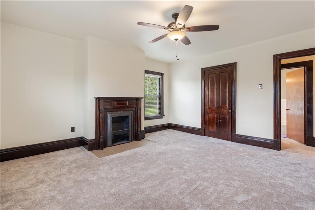 373 Searight Herbert Road Uniontown, PA 15401 - Photo 33 of 40 a view of a livingroom with a fireplace and a chandelier fan