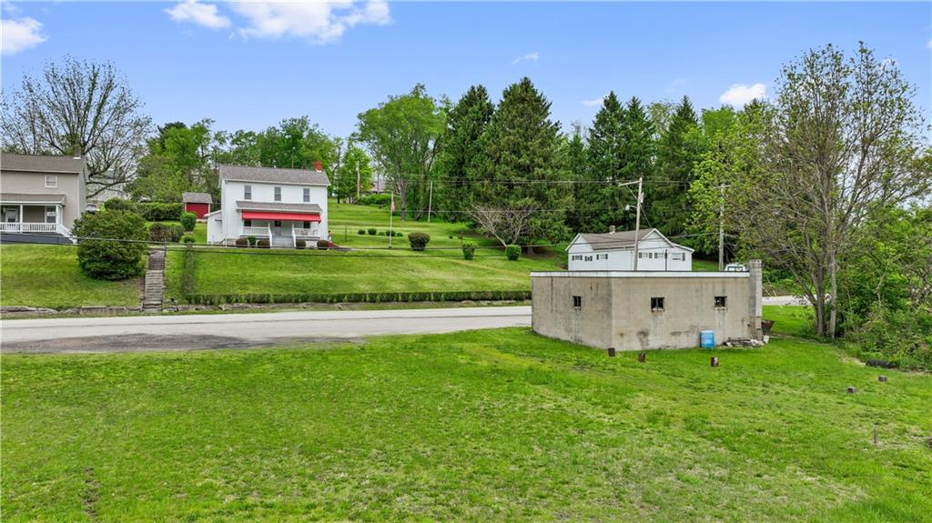 373 Searight Herbert Road Uniontown, PA 15401 - Photo 10 of 40 a front view of a house with a garden and deck