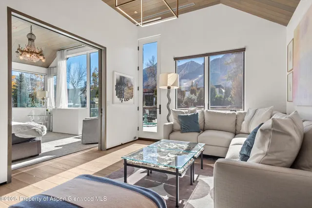a bedroom with a bed couch and a window
