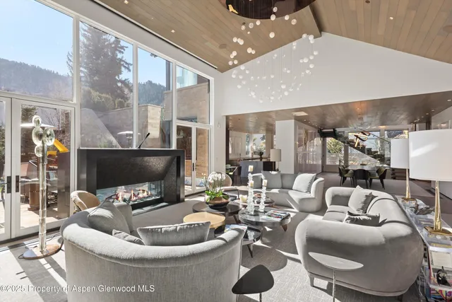 a dining room with furniture and a large window