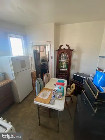 a view of a workspace with furniture and window