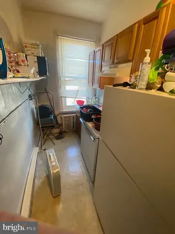 a kitchen with a sink appliances and cabinets