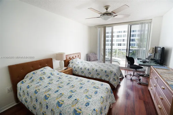 a bedroom with two beds and a chandelier