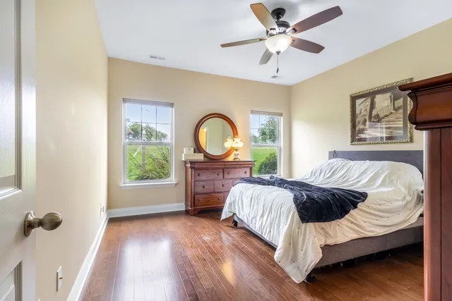 a bedroom with a bed couch and a window