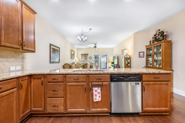 a kitchen with granite countertop a sink and cabinets