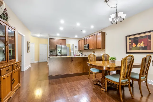a view of a dining room with furniture and wooden floor