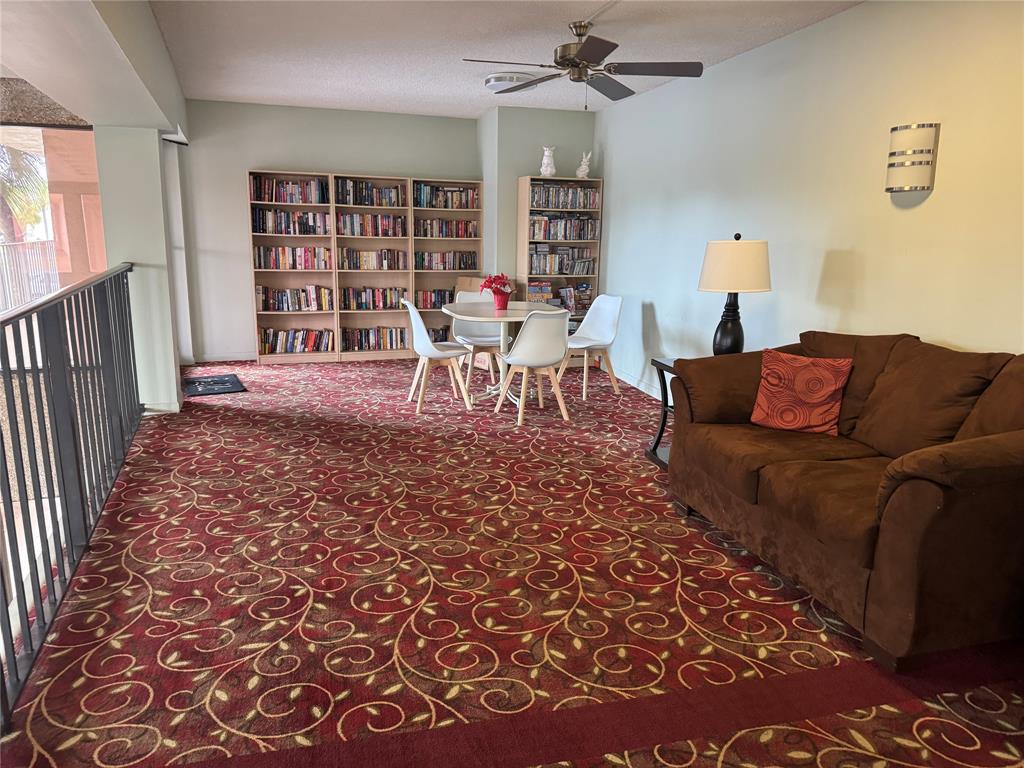9300 Southwest 8th Street, Unit 215 Boca Raton, FL 33428 - Photo 11 of 43 a living room with furniture and a rug