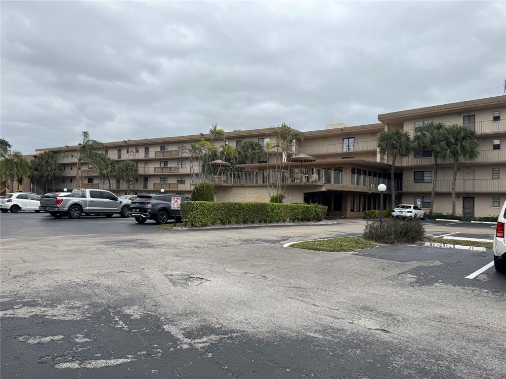 9300 Southwest 8th Street, Unit 215 Boca Raton, FL 33428 - Photo 2 of 43 a car parked in front of a house