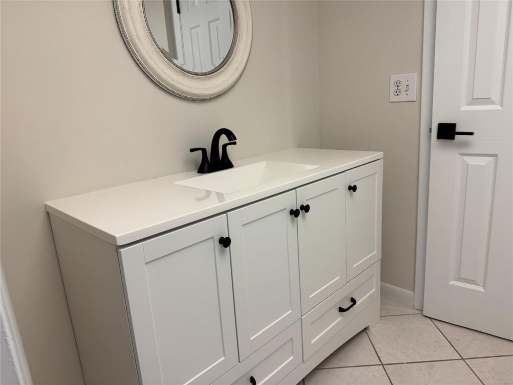 9300 Southwest 8th Street, Unit 215 Boca Raton, FL 33428 - Photo 28 of 43 a bathroom with a sink and a mirror