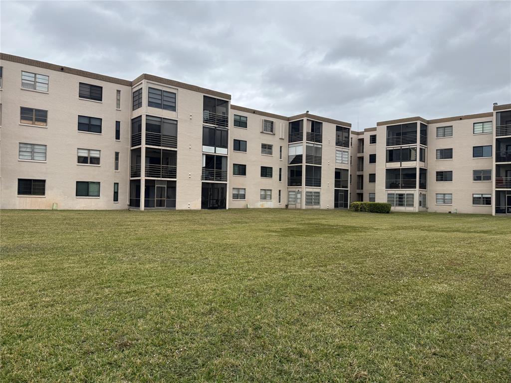 9300 Southwest 8th Street, Unit 215 Boca Raton, FL 33428 - Photo 4 of 43 a large building with a garden