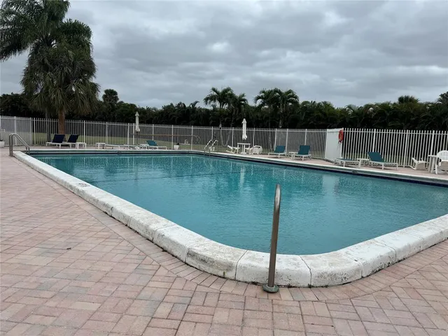a view of a swimming pool with a yard