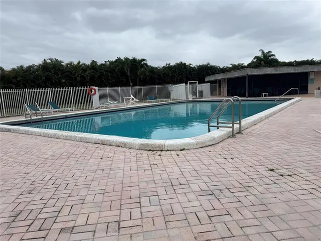 a view of a swimming pool with a yard