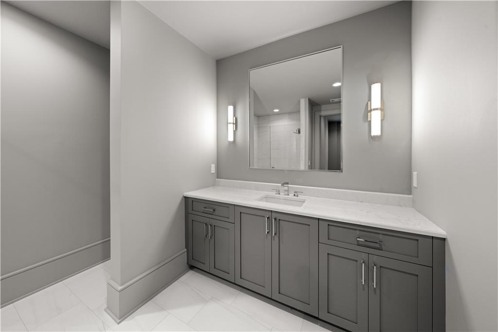 5211 Powers Ferry Road Northwest Sandy Springs, GA 30327 - Photo 73 of 106 a bathroom with a double vanity sink and mirror