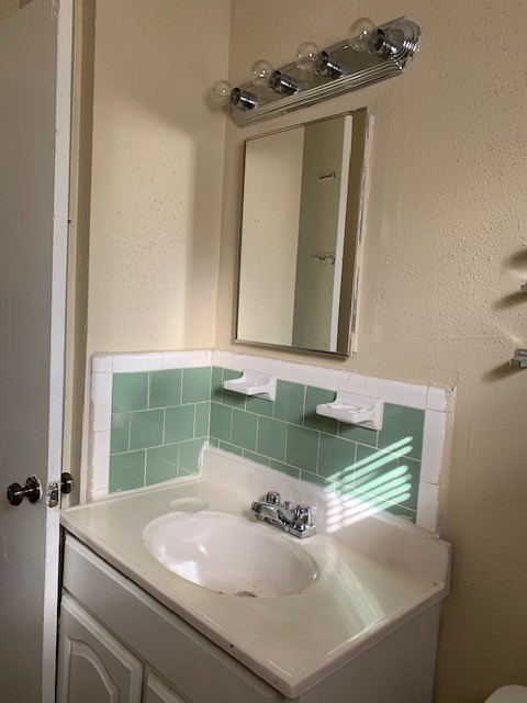 7812 Tierwester Street, Unit 120 Houston, TX 77021 - Photo 1 of 6 a bathroom with a sink and a mirror