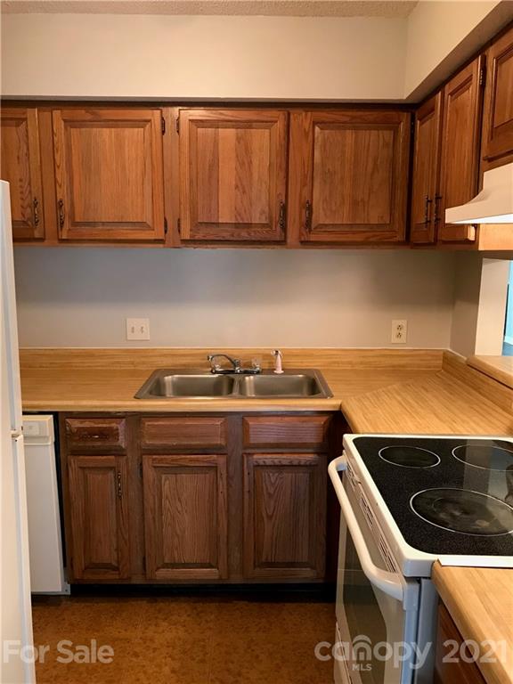 1604 Sharon Road West, Unit 22 Charlotte, NC 28210 - Photo 11 of 23 a stove top oven sitting inside of a kitchen