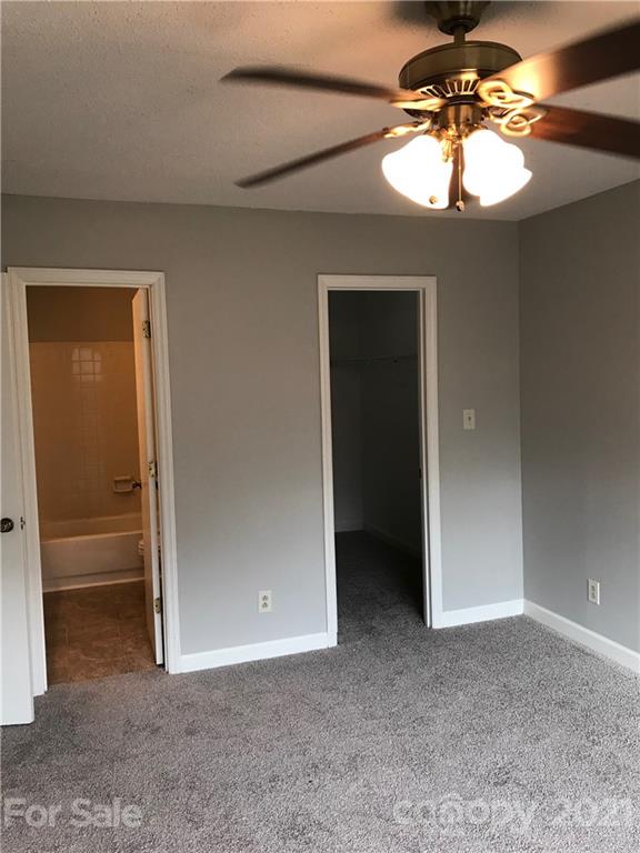 1604 Sharon Road West, Unit 22 Charlotte, NC 28210 - Photo 15 of 23 an empty room with closet and a chandelier fan