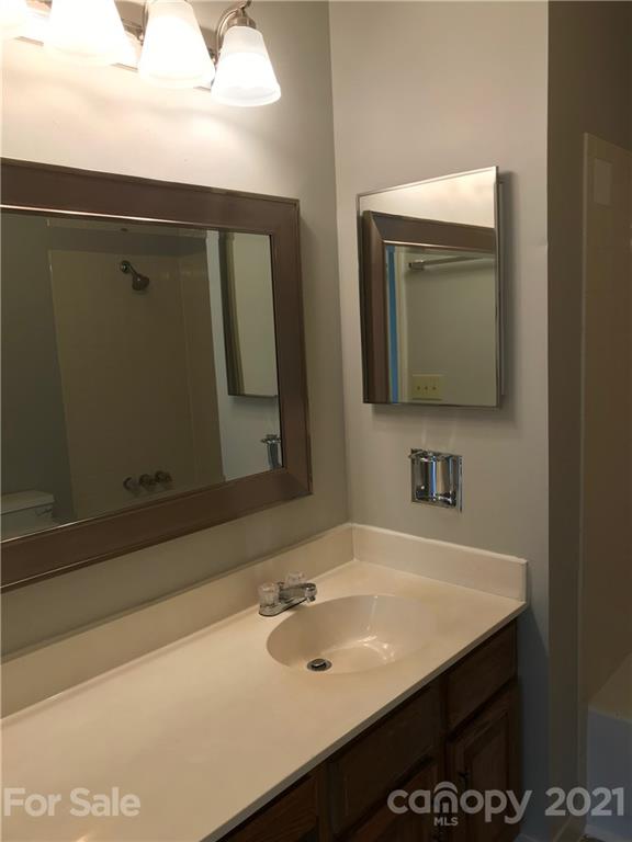 1604 Sharon Road West, Unit 22 Charlotte, NC 28210 - Photo 17 of 23 a bathroom with a sink vanity and mirror
