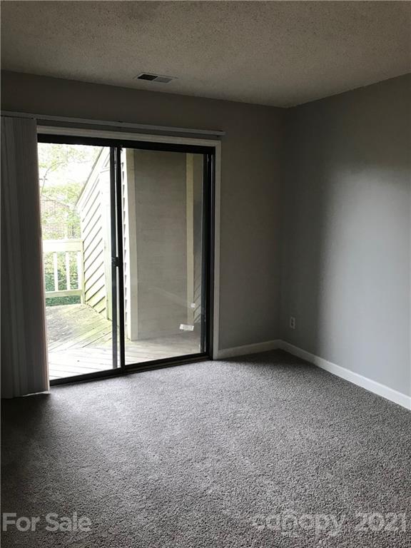 1604 Sharon Road West, Unit 22 Charlotte, NC 28210 - Photo 20 of 23 a view of an empty room with a window