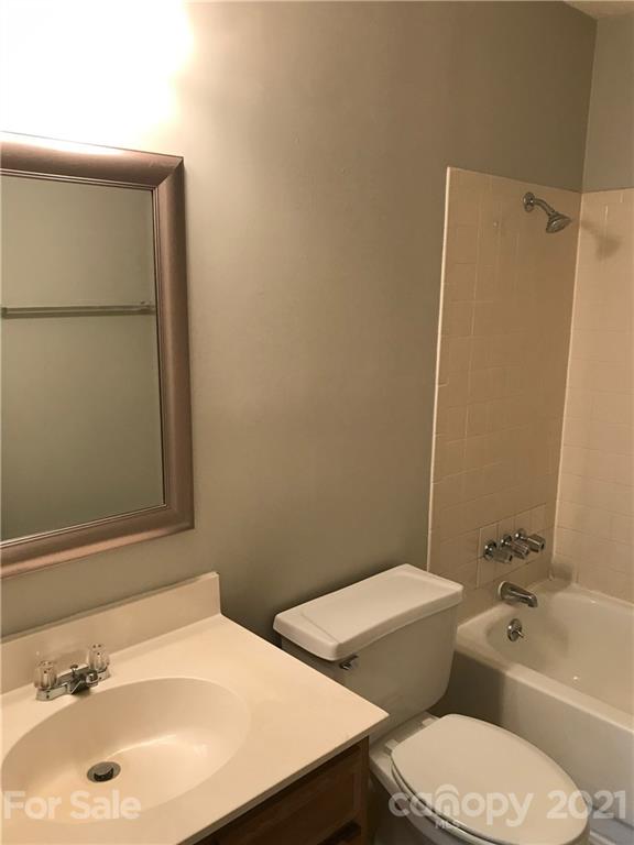 1604 Sharon Road West, Unit 22 Charlotte, NC 28210 - Photo 22 of 23 a bathroom with a sink a toilet and shower