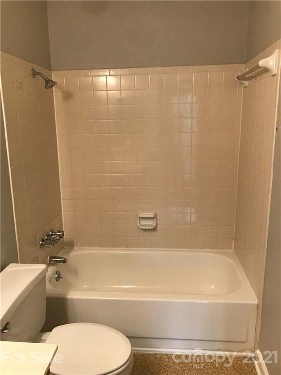 1604 Sharon Road West, Unit 22 Charlotte, NC 28210 - Photo 23 of 23 a bathroom with a bathtub toilet and shower