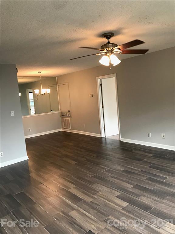 1604 Sharon Road West, Unit 22 Charlotte, NC 28210 - Photo 7 of 23 a view of a room with wooden floor and a ceiling fan