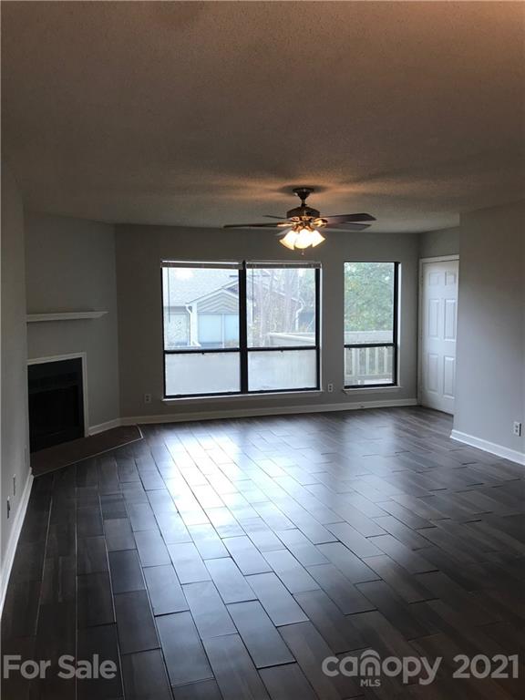 1604 Sharon Road West, Unit 22 Charlotte, NC 28210 - Photo 9 of 23 an empty room with wooden floor and windows
