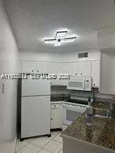 a white refrigerator freezer and a stove