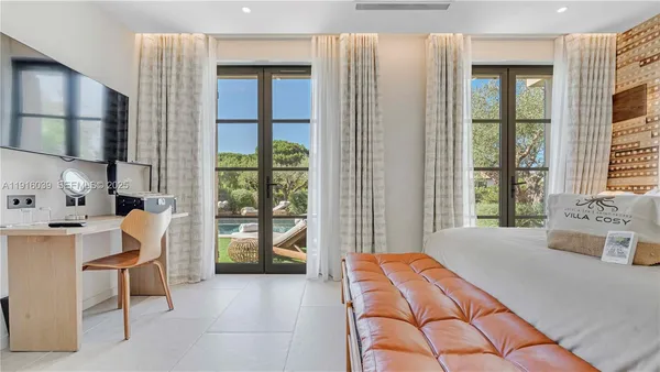 a view of a hallway with wooden floor and living room