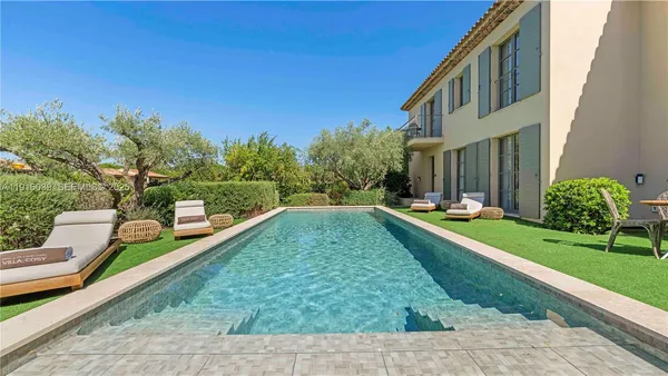 a view of a house with swimming pool and a yard